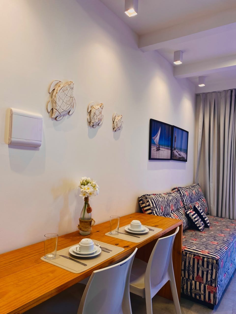 Sala do chalé com sofá-cama e mesa de refeições